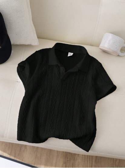 Black shirt on a beige sofa with a white pillow and mug in the background